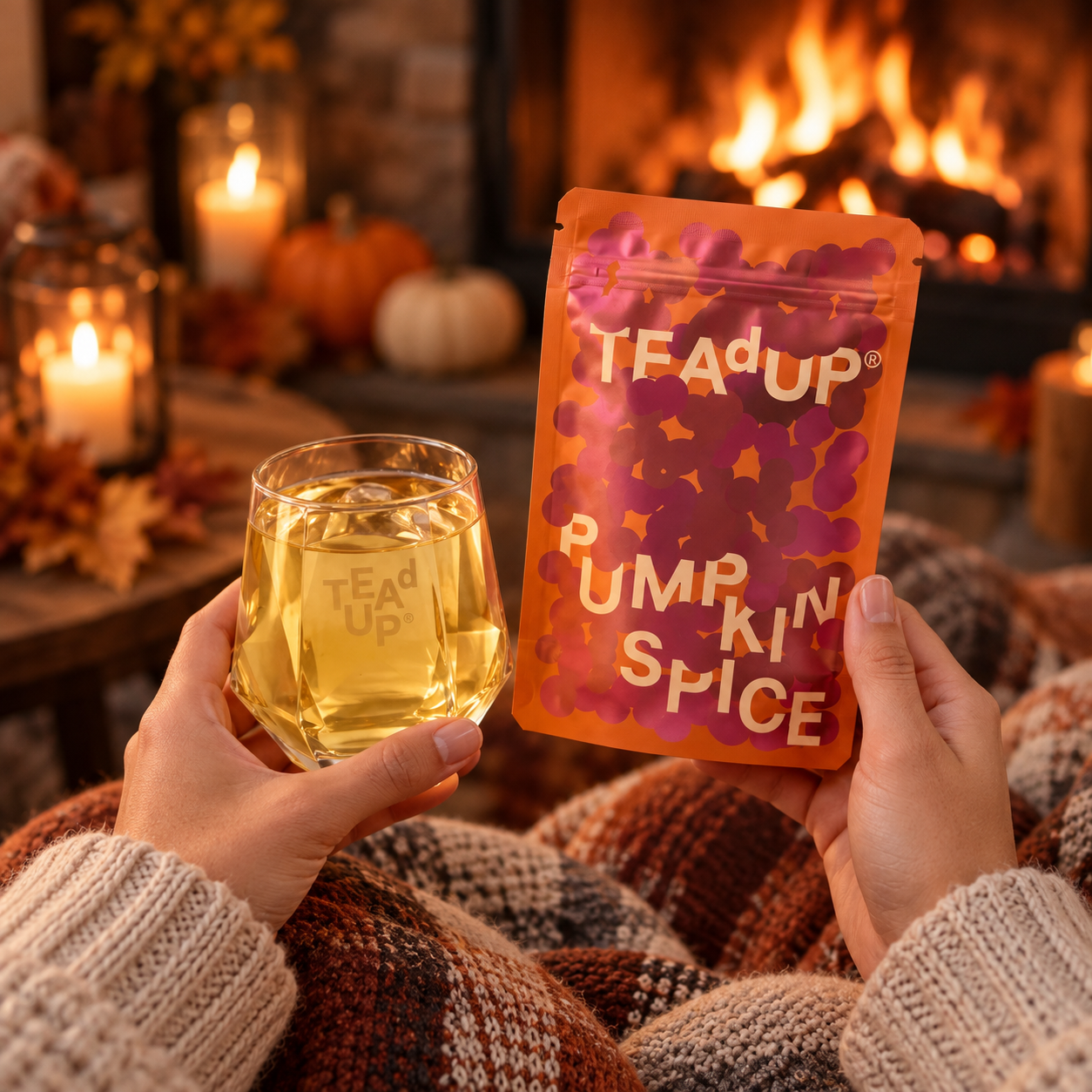 Hände halten Pumpkin Spice Packung und Drink am Kaminfeuer
